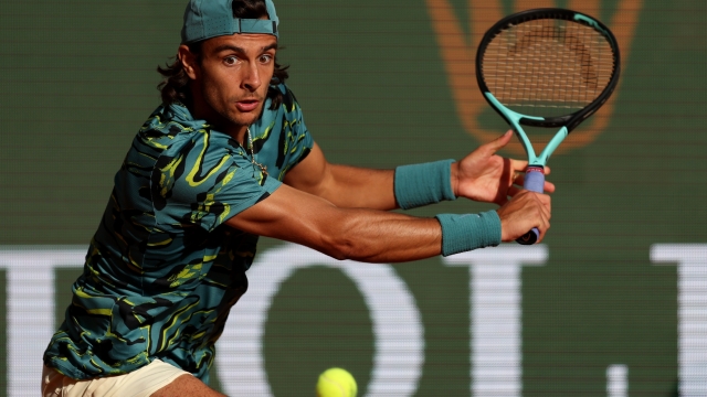 MONTE-CARLO, MONACO - APRIL 13:  Lorenzo Musetti of Italy plays a backhand against Novak Djokovic of Serbia in their third round match during day five of the Rolex Monte-Carlo Masters at Monte-Carlo Country Club on April 13, 2023 in Monte-Carlo, Monaco. (Photo by Clive Brunskill/Getty Images)