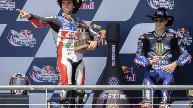 Spain's Alex Rins, left, celebrates after his win with France's Fabio Quartararo, who finished third, after the MotoGP Grand Prix of the Americas motorcycle race at Circuit of the Americas, Sunday, April 16, 2023, in Austin, Texas. (AP Photo/Darren Abate)