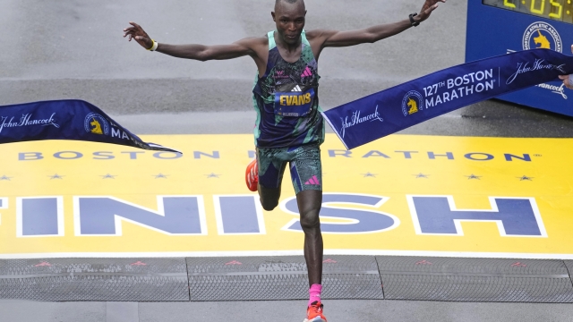 Evans Chebet, of Kenya, breaks the tape at the finish line, winning the Boston Marathon, Monday, April 17, 2023, in Boston. (AP Photo/Charles Krupa)