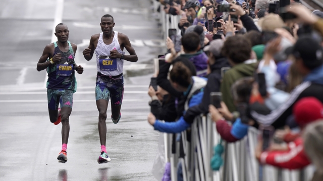 Evans Chebet, of Kenya, left, runs near Gabriel Geay, of Tanzania, right, along the course of the 127th Boston Marathon, Monday, April 17, 2023, in Brookline, Mass. Chebet went on to win the race. (AP Photo/Steven Senne)