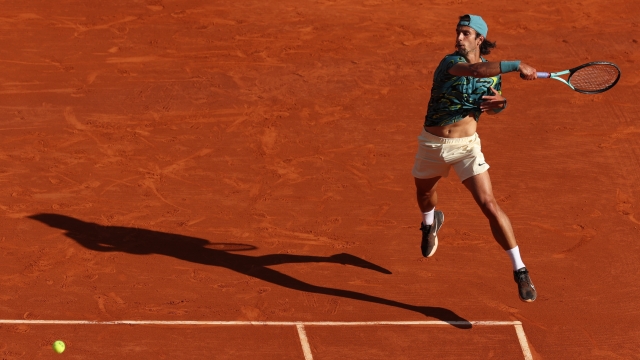 MONTE-CARLO, MONACO - APRIL 14: Lorenzo Musetti of Italy plays a forehand against Jannik Sinner of Italy in their quarterfinal match during day six of the Rolex Monte-Carlo Masters at Monte-Carlo Country Club on April 14, 2023 in Monte-Carlo, Monaco. (Photo by Clive Brunskill/Getty Images)