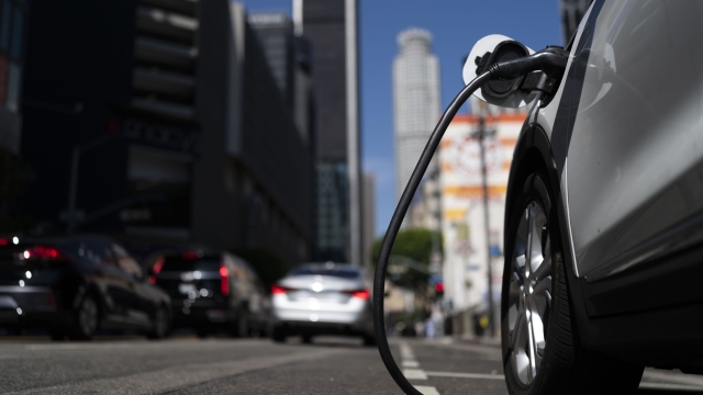 FILE - An electric vehicle is plugged into a charger in Los Angeles, Aug. 25, 2022. Ten electric or plug-in hybrid vehicles will be eligible for a $7,500 U.S. tax credit, while another seven could get $3,750 under new federal rules that go into effect on Tuesday, April 18, 2023. (AP Photo/Jae C. Hong, File)