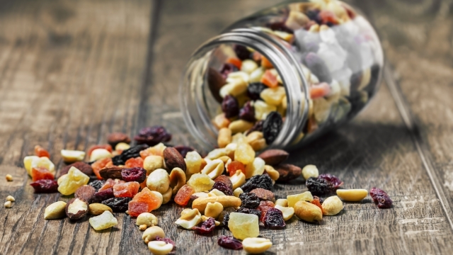 Trail mix in a jar on wooden background