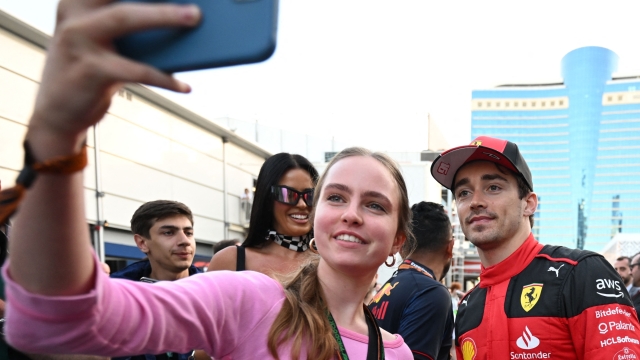 Ferrari's Monegasque driver Charles Leclerc poses for pictures with fans after the sprint race ahead of the Formula One Azerbaijan Grand Prix at the Baku City Circuit in Baku on April 29, 2023. (Photo by NATALIA KOLESNIKOVA / AFP)