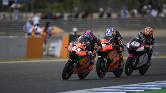 (From L) Red Bull KTM's Turkish rider Deniz Oncu rides ahead of Red Bull KTM Tech 3's Spanish rider Daniel Holgado and Angeluss MTA Team KTM's Ivan Ortola during the Moto3 race of the Spanish Grand Prix at the Jerez Circuit in Jerez de la Frontera on April 30, 2023. (Photo by JORGE GUERRERO / AFP)