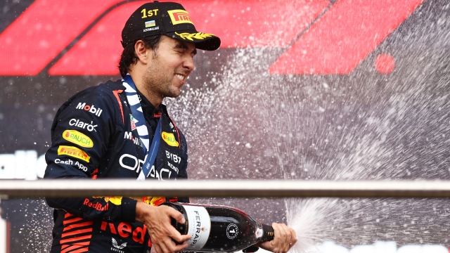 BAKU, AZERBAIJAN - APRIL 30: Race winner Sergio Perez of Mexico and Oracle Red Bull Racing celebrates on the podium during the F1 Grand Prix of Azerbaijan at Baku City Circuit on April 30, 2023 in Baku, Azerbaijan. (Photo by Alex Pantling/Getty Images)