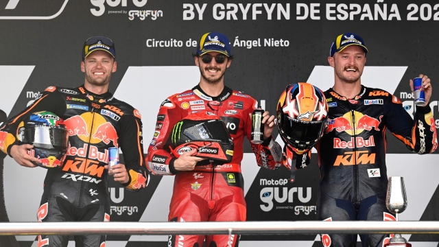First placed Ducati Italian rider Francesco Bagnaia (C), second placed Red Bull KTM's South African rider Brad Binder (L) and third placed KTM Australian rider Jack Miller celebrate after the MotoGP Spanish Grand Prix at the Jerez racetrack in Jerez de la Frontera on April 30, 2023. (Photo by JORGE GUERRERO / AFP)