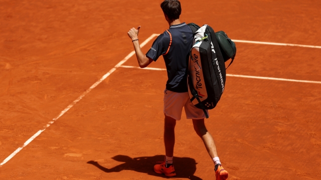MADRID, SPAIN - MAY 02: Daniil Medvedev gives a thumbs up as they leave the court after defeat against Aslan Karatsev in the Men's Singles Fourth Round match on Day Nine of the Mutua Madrid Open at La Caja Magica on May 02, 2023 in Madrid, Spain. (Photo by Clive Brunskill/Getty Images)
