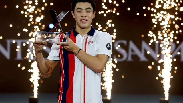 MILAN, ITALY - NOVEMBER 12: Brandon Nakashima of United States  poses with the winner's trophy after defeating Jiri Lehecka of Czech Republic during the final on Day Five of the Next Gen ATP Finals at Allianz Cloud on November 12, 2022 in Milan, Italy. (Photo by Matthew Stockman/Getty Images)