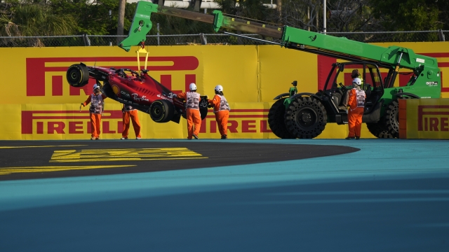 Marshalls prepare to load the damaged car of Ferrari driver Charles Leclerc, of Monaco, onto a trailer at the end of the second practice session of the Formula One Miami Grand Prix auto race at Miami International Autodrome in Miami Gardens, Fla., Friday, May 5, 2023. (AP Photo/Rebecca Blackwell)