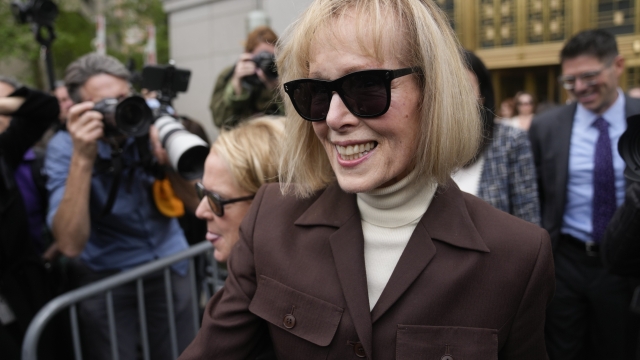 E. Jean Carroll, center, walks out of Manhattan federal court, Tuesday, Dec. 9, 2023, in New York. A jury has found Donald Trump liable for sexually abusing the advice columnist in 1996, awarding her $5 million in a judgment that could haunt the former president as he campaigns to regain the White House. (AP Photo/Seth Wenig)