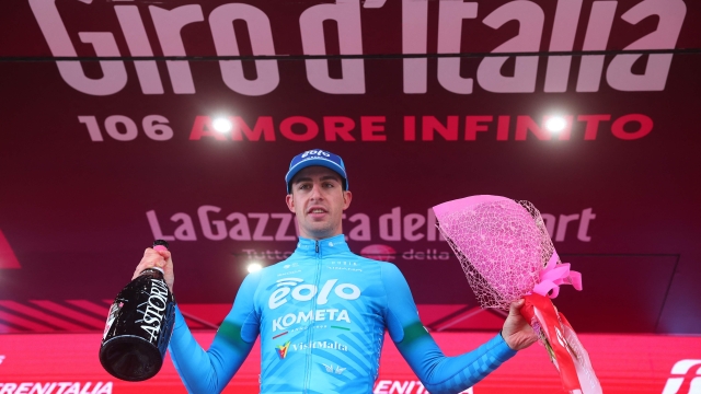 EOLO-Kometa's Italian rider Davide Bais celebrates on the podium after winning the seventh stage of the Giro d'Italia 2023 cycling race, 218 km between Capua and Gran Sasso d'Italia, on May 12, 2023. (Photo by Luca Bettini / AFP)