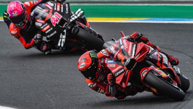 Ducati Lenovo Team's Italian rider Pecco  Bagnaia (R) and  Aprilia Racing Team Spanish rider Aleix Espargaro (L) ride during the 2nd free practice session ahead of the French MotoGP Grand Prix race of the French motorcycling Grand Prix, in Le Mans, northwestern France, on May 12, 2023. (Photo by Jean-Francois MONIER / AFP)