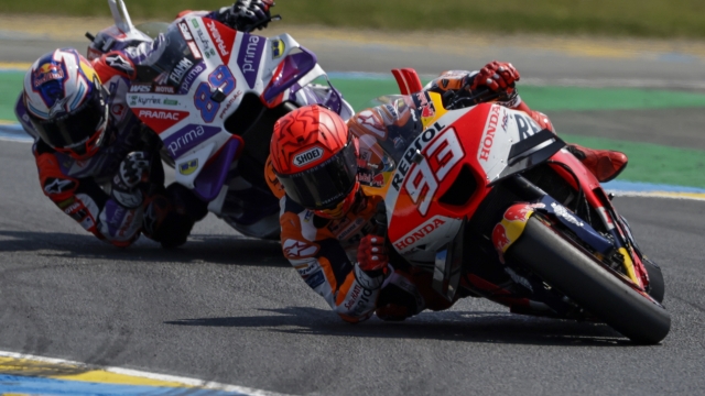 Spain's rider Marc Marquez of the Repsol Honda Team steers his motorcycle followed by Spain's rider Jorge Martin of the Prima Pramac Racing during the MotoGP race of the French Motorcycle Grand Prix at the Le Mans racetrack, in Le Mans, France, Sunday, May 14, 2023. (AP Photo/Jeremias Gonzalez)
