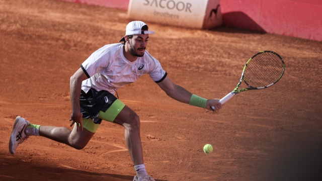 Giulio Zeppieri from Italy in action against Joao Sousa from Portugal in the Round of 32 at the Estoril Open tennis tournament in Estoril, Portugal, 04 April 2023.  EPA/MIGUEL A. LOPES