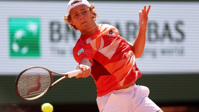 PARIS, FRANCE - MAY 29: Aleksandar Kovacevic of United States plays a forehand against Novak Djokovic of Serbia during their Men's Singles First Round Match on Day Two of the 2023 French Open at Roland Garros on May 29, 2023 in Paris, France. (Photo by Clive Brunskill/Getty Images)