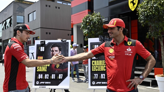 Ferrari's Monegasque driver Charles Leclerc (L) and Ferrari's Spanish driver Carlos Sainz Jr greet each other before a press conference ahead of the Spanish Formula One Grand Prix at the Circuit de Catalunya on June 1, 2023 in Montmelo, on the outskirts of Barcelona. (Photo by JAVIER SORIANO / AFP)