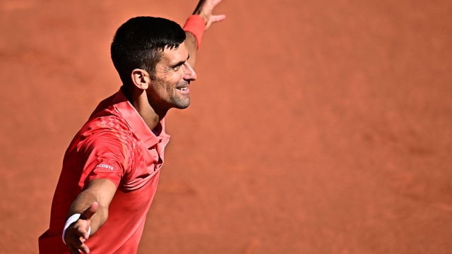 Serbia's Novak Djokovic celebrates his victory over Peru's Juan Pablo Varillas during their men's singles match on day eight of the Roland-Garros Open tennis tournament at the Court Philippe-Chatrier in Paris on June 4, 2023. (Photo by JULIEN DE ROSA / AFP)