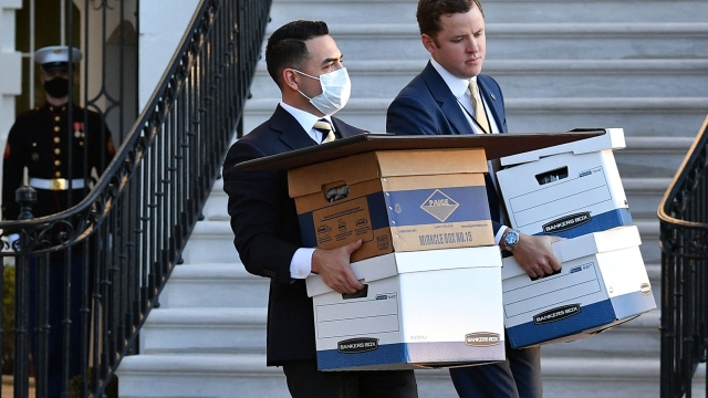 (FILES) A January 20, 2021 photo shows aides carrying  boxes to Marine One before US president Donald Trump and wife Melania Trump departed from the White House on Trump's final day in office, in Washington, DC. Former US president Donald Trump said June 8, 2023 he has been indicted in the federal probe over his handling of classified documents after leaving office. (Photo by MANDEL NGAN / AFP)