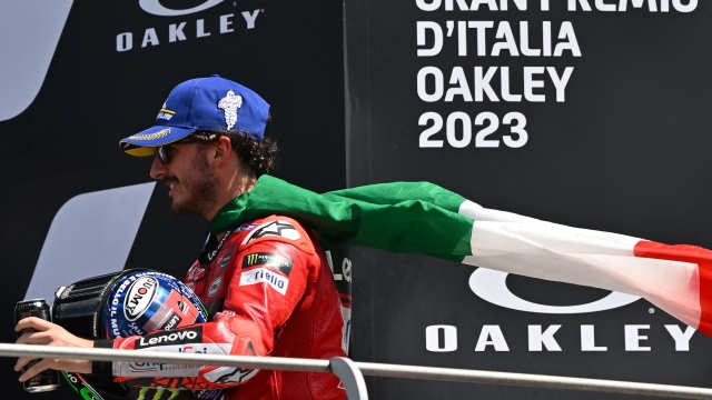 Winner Ducati Italian rider Francesco Bagnaia celebrates after the Italian MotoGP race at Mugello Circuit in Mugello, on June 11, 2023. (Photo by Filippo MONTEFORTE / AFP)