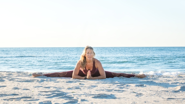 caucasian healthy adult woman with beautiful body doing yoga at sunrise on the beach, yoga poses