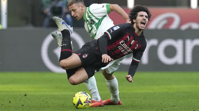 AC Milan's Sandro Tonali is fouled by Sassuolo's Davide Frattesi, during a Serie A soccer match between AC Milan and Sassuolo at the San Siro stadium in Milan, Italy, Sunday, Jan. 29, 2023. (AP Photo/Antonio Calanni)