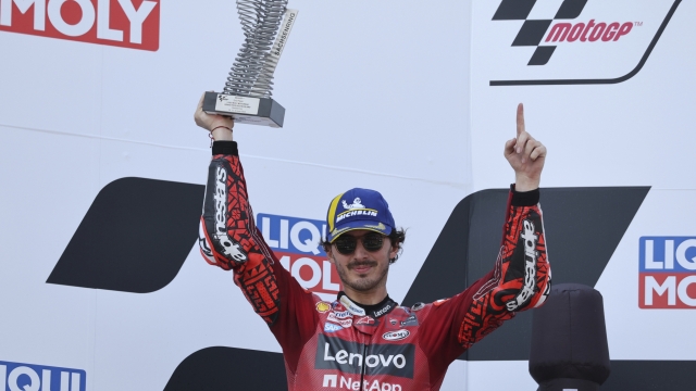 Italy's Francesco Bagnaia celebrates on the podium after taking second place in the German Grand Prix MotoGP, at the Sachsenring racing circuit, in Hohenstein-Ernstthal, Germany, Sunday, June 18, 2023. (Jan Woitas/dpa via AP)