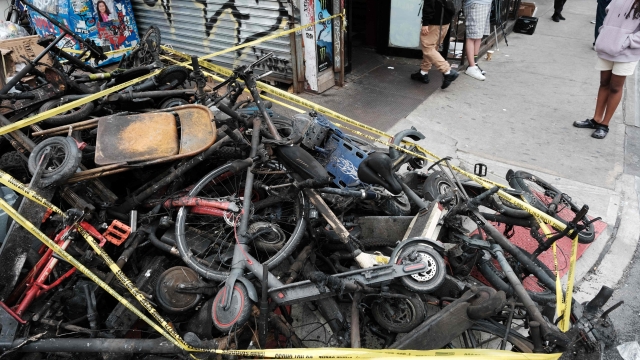 NEW YORK, NEW YORK - JUNE 20: Charred remains of e-bikes and scooters sit outside of a building in Chinatown after four people were killed by a fire in an e-bike repair shop overnight on June 20, 2023 in New York City. Lithium-ion e-bike batteries have caused numerous fires and fatalities in recent years due to the rising popularity of e-bikes for delivery purposes. New York City Mayor Eric Adams' administration has taken strong measures against unregulated e-bike and e-scooter batteries, which often present the highest risk when improperly charged.   Spencer Platt/Getty Images/AFP (Photo by SPENCER PLATT / GETTY IMAGES NORTH AMERICA / Getty Images via AFP)
