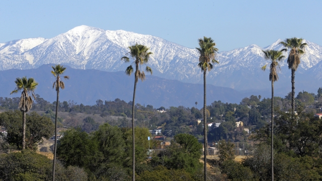FILE - The snow-capped San Gabriel Mountains, with Mount Baldy the highest peak at the left, as seen from Chinatown near downtown Los Angeles, Jan. 12, 2016.  Authorities say the latest search for missing actor Julian Sands on Southern California's massive Mount Baldy was unsuccessful. Sands was reported missing in January 2023 after setting out to hike on Mount Baldy, which rises more than 10,000 feet east of Los Angeles and was pounded by severe winter storms. (AP Photo/Nick Ut, File)