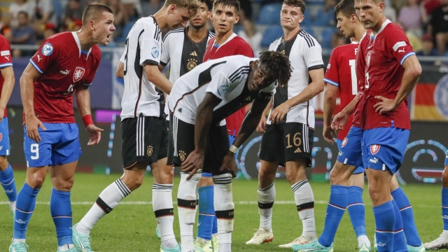 epa10711207 Kenneth Schmidt (2nd-L) and Yann Bisseck (C) of Germany react after the team lost the UEFA Under-21 Championship group stage match between the Czech Republic and Germany in Batumi, Georgia, 25 June 2023.  EPA/YURI KOCHETKOV