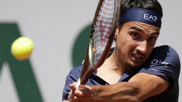 Italy's Lorenzo Sonego plays a shot against Russia's Karen Khachanov during their fourth round match of the French Open tennis tournament at the Roland Garros stadium in Paris, Sunday, June 4, 2023. (AP Photo/Christophe Ena)