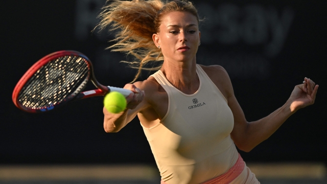 Italy's Camila Giorgi returns to Latvia's Jelena Ostapenko during their women's singles quarter-final tennis match at the Rothesay Eastbourne International tennis tournament in Eastbourne, southern England, on June 29, 2023. (Photo by Glyn KIRK / AFP)