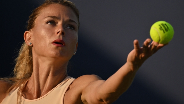 Italy's Camila Giorgi serves to Latvia's Jelena Ostapenko during their women's singles quarter-final tennis match at the Rothesay Eastbourne International tennis tournament in Eastbourne, southern England, on June 29, 2023. (Photo by Glyn KIRK / AFP)
