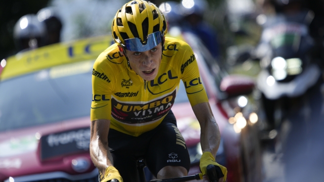 Stage winner Denmark's Jonas Vingegaard, wearing the overall leader's yellow jersey, climbs Hautacam after breaking away from his opponent Slovenia's Tadej Pogacar during the eighteenth stage of the Tour de France cycling race over 143.5 kilometers (89.2 miles) with start in Lourdes and finish in Hautacam, France, Thursday, July 21, 2022. (AP Photo/Daniel Cole)