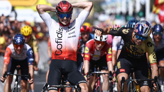 Jumbo-Visma's Belgian rider Wout Van Aert (R) reacts as Cofidis' French rider Victor Lafay (L) celebrates after winning the 2nd stage of the 110th edition of the Tour de France cycling race 208,9 km between Vitoria-Gasteiz and San Sebastian, in northern Spain, on July 2, 2023. (Photo by Anne-Christine POUJOULAT / AFP)