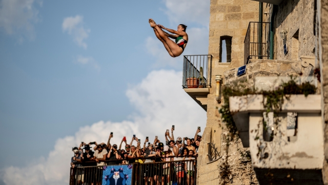Elisa Cosetti of Italy dives from the 20 metre balcony during the first competition day of the third stop of the Red Bull Cliff Diving World Series in Polignano a Mare, Italy on July 01, 2023. // Dean Treml / Red Bull Content Pool // SI202307010971 // Usage for editorial use only //