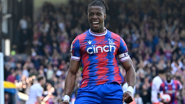 Crystal Palace's Ivorian striker Wilfried Zaha celebrates after scoring their second goal during the English Premier League football match between Crystal Palace and West Ham United at Selhurst Park in south London on April 29, 2023. (Photo by JUSTIN TALLIS / AFP) / RESTRICTED TO EDITORIAL USE. No use with unauthorized audio, video, data, fixture lists, club/league logos or 'live' services. Online in-match use limited to 120 images. An additional 40 images may be used in extra time. No video emulation. Social media in-match use limited to 120 images. An additional 40 images may be used in extra time. No use in betting publications, games or single club/league/player publications. /