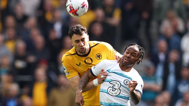 Wolverhampton Wanderers' English defender Max Kilman (L) vies with Chelsea's English midfielder Raheem Sterling (R) during the English Premier League football match between Wolverhampton Wanderers and Chelsea at the Molineux stadium in Wolverhampton, central England on April 8, 2023. (Photo by Darren Staples / AFP) / RESTRICTED TO EDITORIAL USE. No use with unauthorized audio, video, data, fixture lists, club/league logos or 'live' services. Online in-match use limited to 120 images. An additional 40 images may be used in extra time. No video emulation. Social media in-match use limited to 120 images. An additional 40 images may be used in extra time. No use in betting publications, games or single club/league/player publications. /