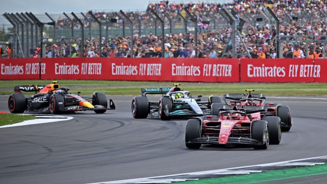 Ferrari's Monegasque driver Charles Leclerc leads Ferrari's Spanish driver Carlos Sainz Jr, Mercedes' British driver Lewis Hamilton and Red Bull Racing's Mexican driver Sergio Perez following a restart by safety car during the Formula One British Grand Prix at the Silverstone motor racing circuit in Silverstone, central England on July 3, 2022. (Photo by JUSTIN TALLIS / AFP)
