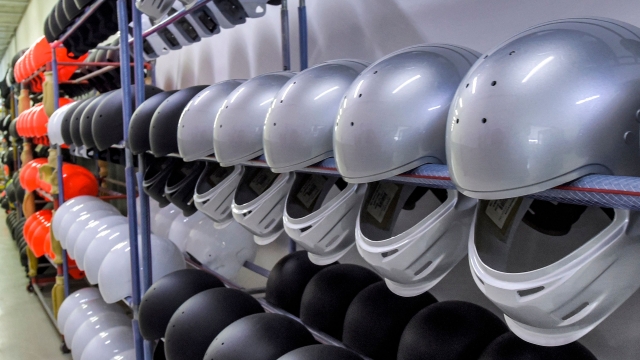 In this picture taken on March 28, 2023 unfinished painted helmets are stacked along a corridor at the Racing Force Group helmet factory on the outskirts of Bahrain International Circuit (BIC) in Sakhir in southern Bahrain. - The small Gulf kingdom of Bahrain is known worldwide for its prestigious Formula One competitions. In the Sakhir desert in the country's south, enthusiasm for the sport has spread to the industrial sector, with a factory locally manufacturing drivers' helmets. (Photo by Mazen Mahdi / AFP)