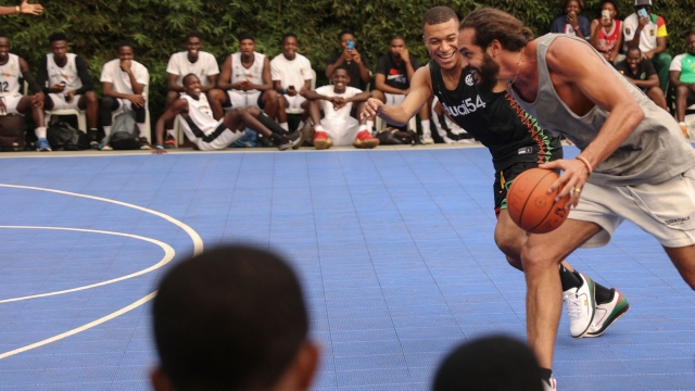 Paris Saint-Germain and France national football team star striker Kylian Mbappe (L) plays basketball with fromer professional basketball player Joakim Noah  (R) at the Club Noah sports complex in Yaounde on July 7, 2023 during a charity visit and a tour of his father's village. (Photo by Daniel BELOUMOU OLOMO / AFP)