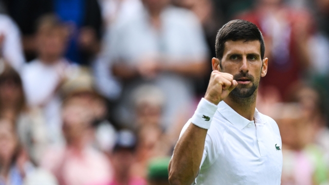 TOPSHOT - Serbia's Novak Djokovic celebrates after winning against Argentina's Pedro Cachin during their men's singles tennis match on the first day of the 2023 Wimbledon Championships at The All England Tennis Club in Wimbledon, southwest London, on July 3, 2023. (Photo by Daniel LEAL / AFP) / RESTRICTED TO EDITORIAL USE