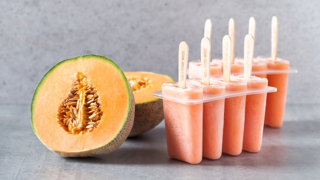 Homemade frozen popsicles made from fresh cantaloupe melon. Healthy summer snack. Selective focus.