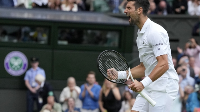 Serbia's Novak Djokovic celebrates after beating Russia's Andrey Rublev to win their men's singles match on day nine of the Wimbledon tennis championships in London, Tuesday, July 11, 2023. (AP Photo/Kirsty Wigglesworth)