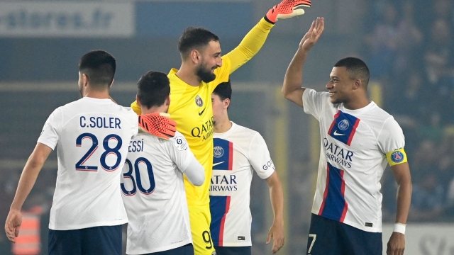 Paris Saint-Germain's Italian goalkeeper Gianluigi Donnarumma celebrates with Paris Saint-Germain's French forward Kylian Mbappe at the end of the French L1 football match between RC Strasbourg Alsace and Paris Saint-Germain (PSG) at Stade de la Meinau in Strasbourg, eastern France on May 27, 2023. (Photo by Jean-Christophe Verhaegen / AFP)