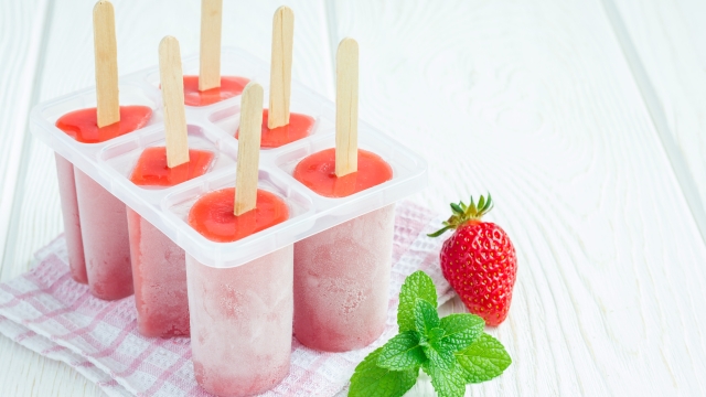 Homemade popsicles with strawberry and banana, copy space