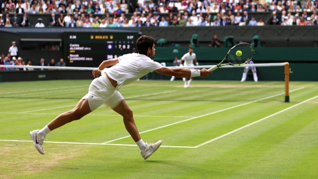 LONDON, ENGLAND - JULY 16: Carlos Alcaraz of Spain plays a forehand in the Men's Singles Final against Novak Djokovic of Serbia on day fourteen of The Championships Wimbledon 2023 at All England Lawn Tennis and Croquet Club on July 16, 2023 in London, England. (Photo by Clive Brunskill/Getty Images)