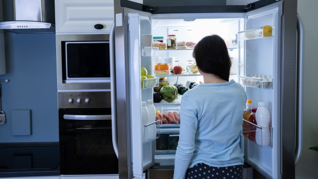 Hungry Woman At Night With Open Fridge