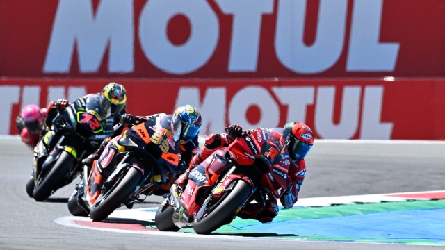 Ducati Lenovo Team's Italian rider Francesco Bagnaia competes ahead of Red Bull KTM Factory Racing's South African rider Brad Binder during the Dutch MotoGP at the TT circuit of Assen, on June 25, 2023. (Photo by John THYS / AFP)