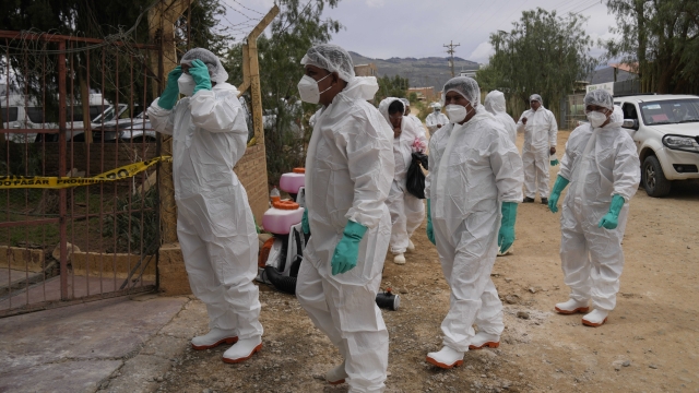 Health workers in protective gear enter a chicken farm during a health alert due to a bird flu outbreak in Sacaba, Bolivia, Tuesday, Jan. 31, 2023. Bolivian health authorities reported on Jan. 30 that thousands of birds were culled after an outbreak of bird flu on farms, forcing the declaration of a 120-day health emergency. (AP Photo/Juan Karita)